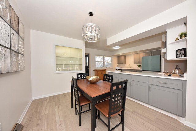 dining space featuring a notable chandelier and light hardwood / wood-style floors