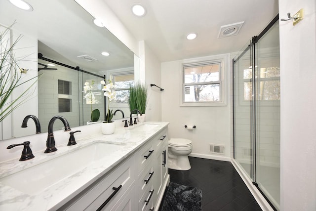 bathroom featuring vanity, a wealth of natural light, toilet, and walk in shower