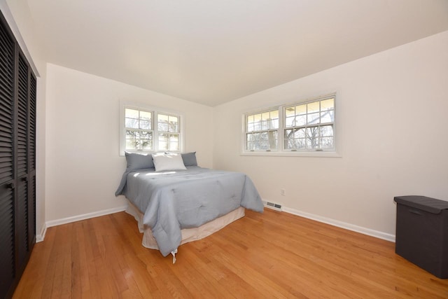 bedroom featuring light wood-type flooring and a closet