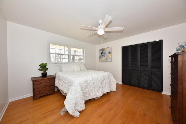 bedroom with hardwood / wood-style floors, ceiling fan, and a closet