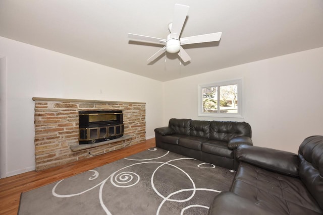 living room featuring a fireplace, dark hardwood / wood-style floors, and ceiling fan