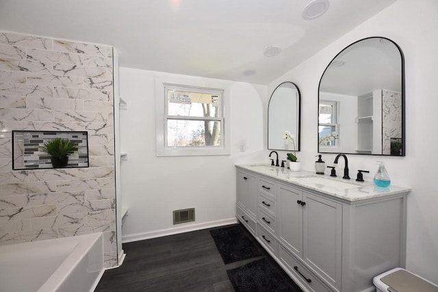 bathroom featuring vanity, hardwood / wood-style floors, and shower / bathing tub combination