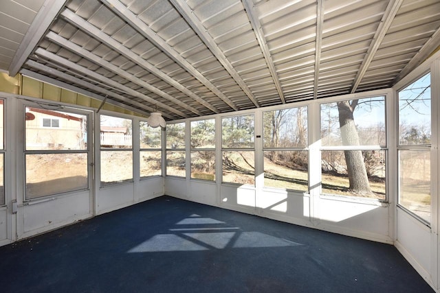 unfurnished sunroom featuring a healthy amount of sunlight and vaulted ceiling