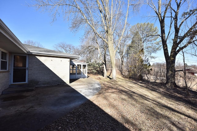 view of yard with a patio area and a sunroom