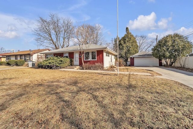 ranch-style home with a garage, an outdoor structure, and a front yard