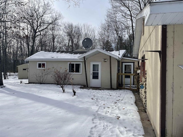 view of snow covered rear of property