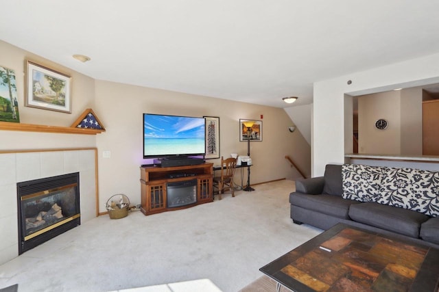 carpeted living room featuring a tiled fireplace