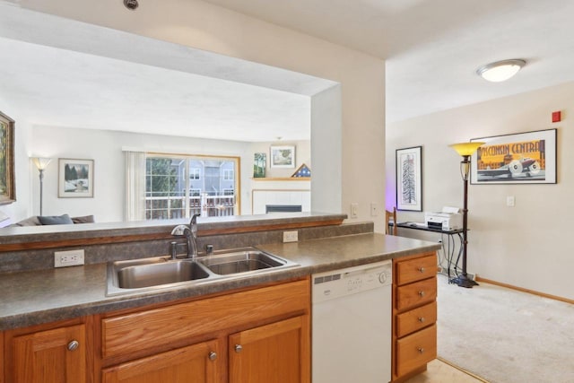 kitchen featuring dark countertops, light carpet, white dishwasher, and a sink