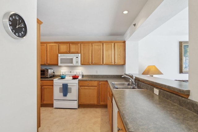 kitchen featuring dark countertops, a toaster, recessed lighting, white appliances, and a sink