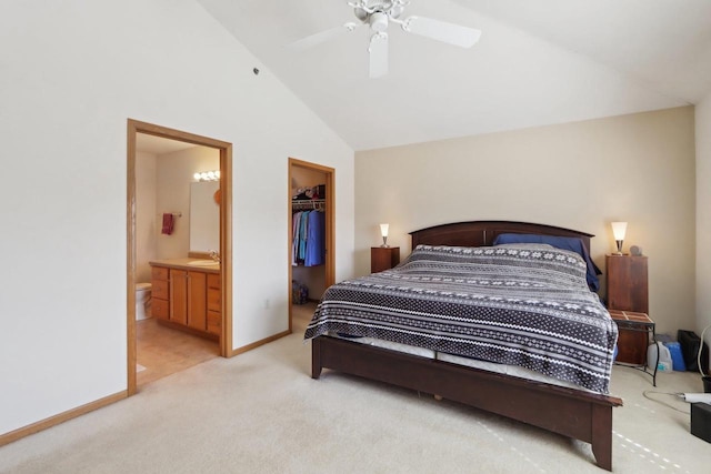 bedroom with light carpet, a sink, a closet, baseboards, and a spacious closet