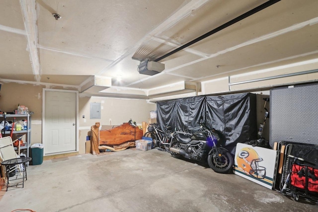 garage featuring electric panel and a garage door opener