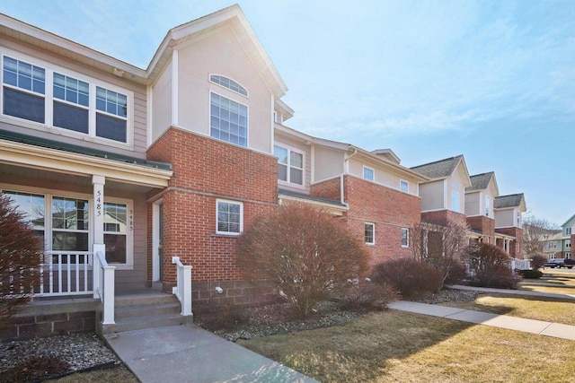 view of side of home with brick siding and a residential view