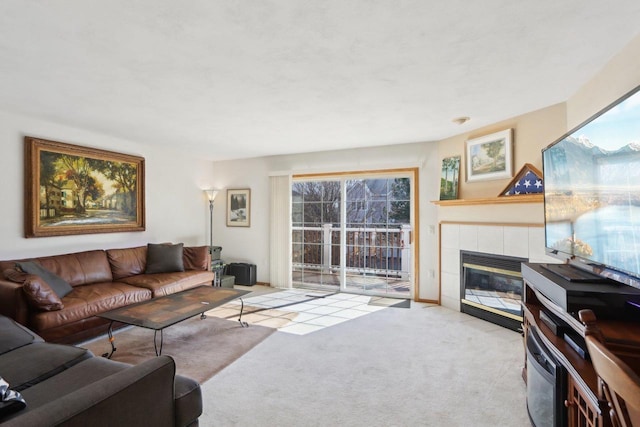 living area featuring carpet floors and a tiled fireplace