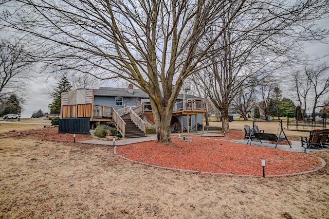 exterior space with a wooden deck and a patio area