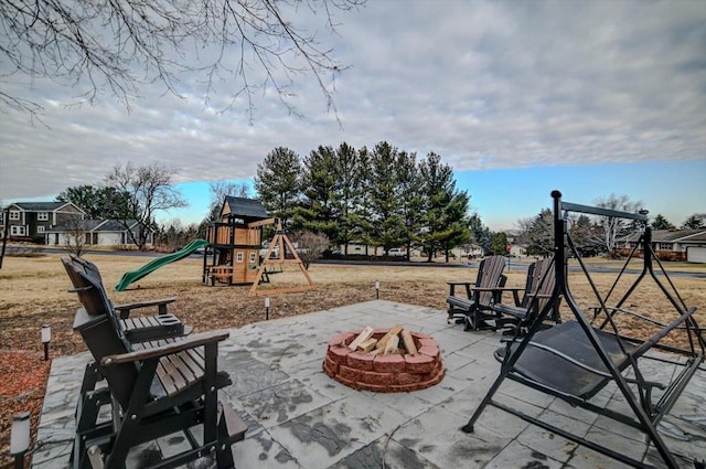 view of patio / terrace featuring a fire pit and a playground