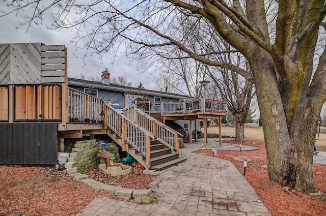 rear view of property featuring a patio and a deck