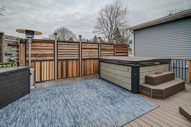 wooden deck with a hot tub