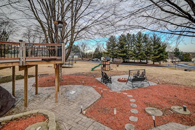 view of yard featuring a playground and a patio