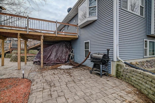 view of patio with a wooden deck and grilling area