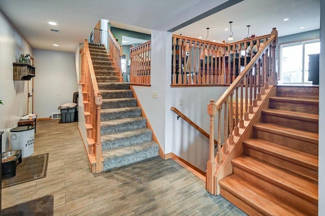 staircase with wood-type flooring