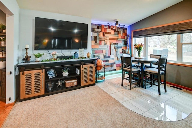 bar with lofted ceiling and tile patterned floors