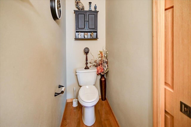 bathroom with wood-type flooring and toilet