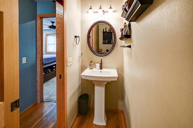 bathroom with hardwood / wood-style floors, sink, and ceiling fan