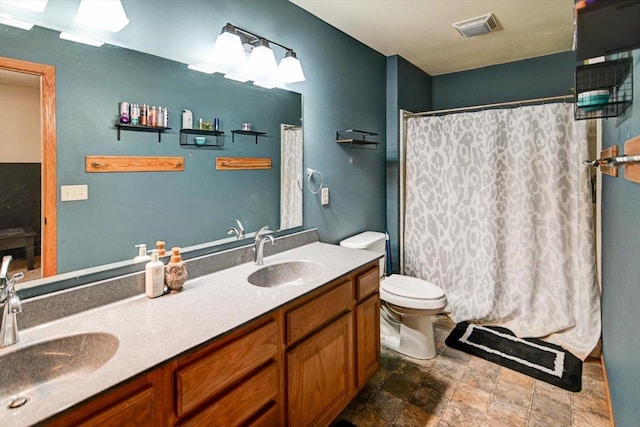 bathroom featuring vanity, toilet, and a shower with shower curtain