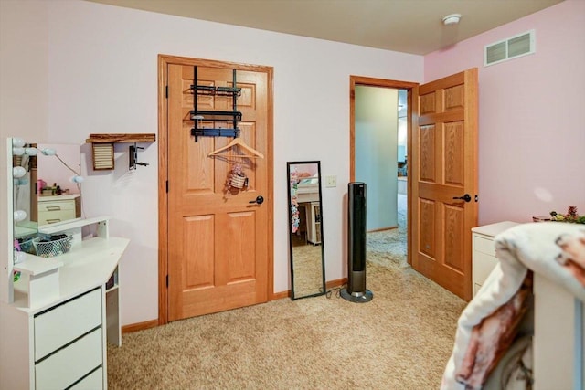 bedroom with light colored carpet