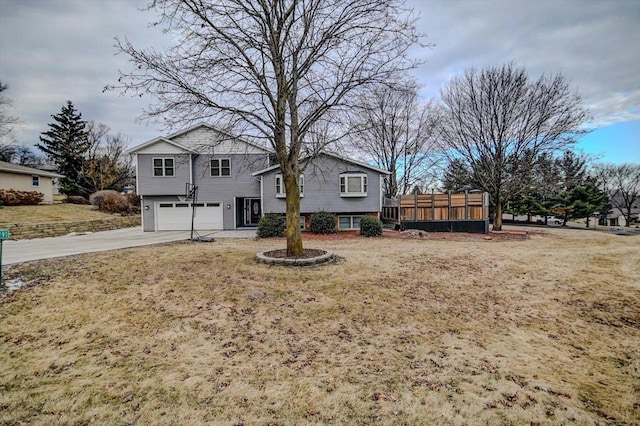 view of front facade with a garage and a front lawn