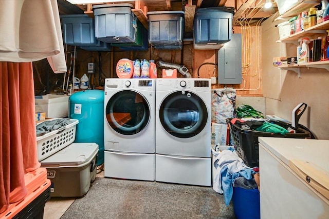 clothes washing area with washing machine and clothes dryer and electric panel