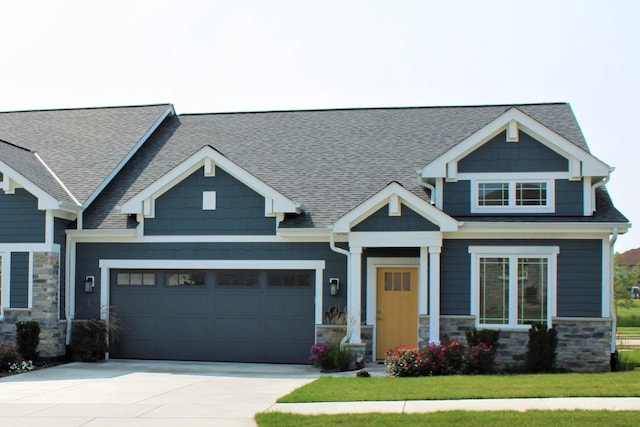 4675 98th St, Pleasant Prairie, WI 53158 - craftsman inspired home featuring an attached garage, driveway, stone siding, a shingled roof, and a front yard