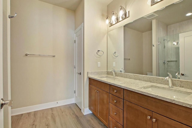 bathroom with vanity, hardwood / wood-style floors, walk in shower, and toilet