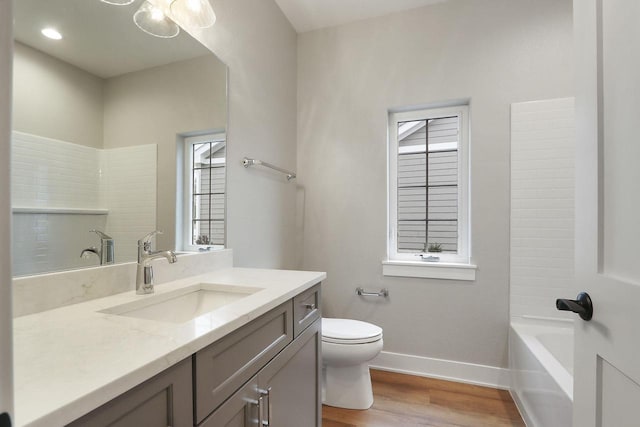 4675 98th St, Pleasant Prairie, WI 53158 - bathroom with vanity, toilet, baseboards, and wood finished floors