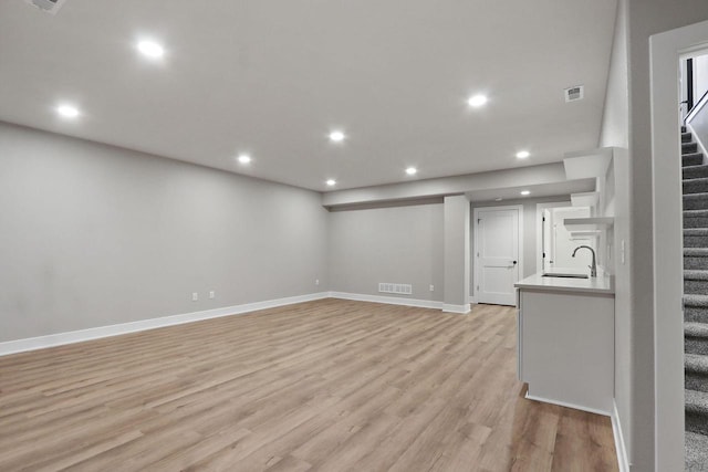 4675 98th St, Pleasant Prairie, WI 53158 - basement featuring stairs, light wood-style flooring, recessed lighting, a sink, and baseboards
