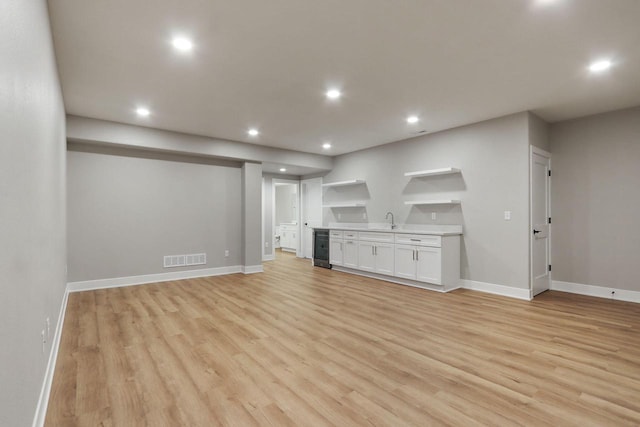 4675 98th St, Pleasant Prairie, WI 53158 - unfurnished living room featuring recessed lighting, light wood finished floors, wet bar, baseboards, and beverage cooler
