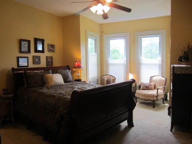 bedroom with ceiling fan and carpet flooring