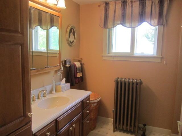 bathroom with vanity and radiator