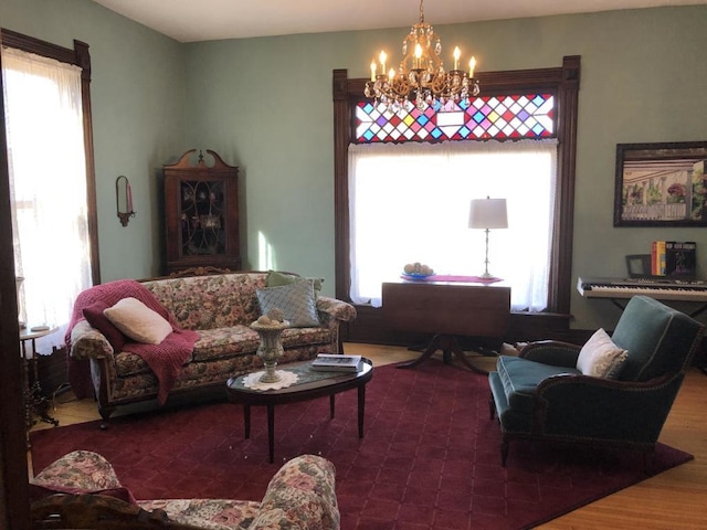 living room with an inviting chandelier and hardwood / wood-style flooring