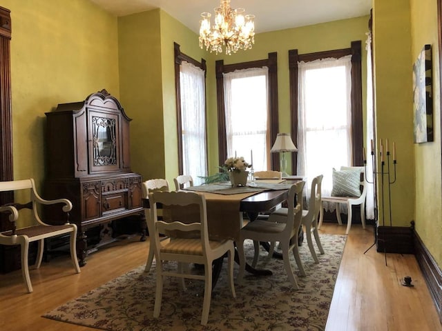 dining room with an inviting chandelier and light hardwood / wood-style floors