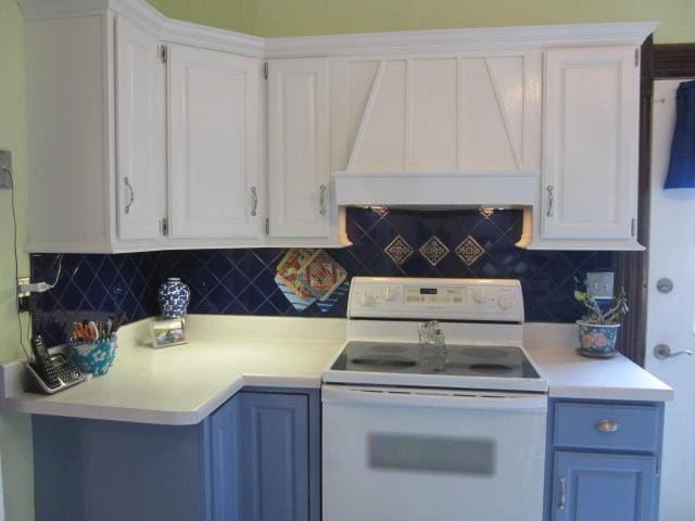 kitchen with custom exhaust hood, tasteful backsplash, white electric range, and white cabinets