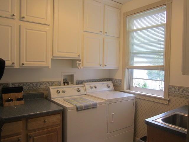 washroom with cabinets and separate washer and dryer