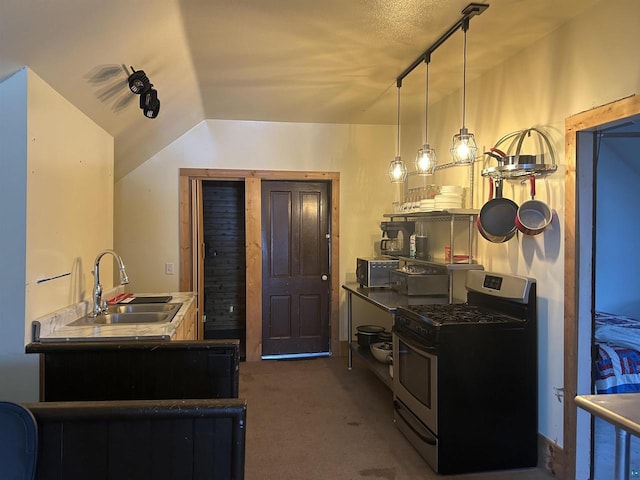 59460 Main St, Mason, WI 54856 - kitchen with lofted ceiling, sink, stainless steel gas range oven, dark carpet, and decorative light fixtures