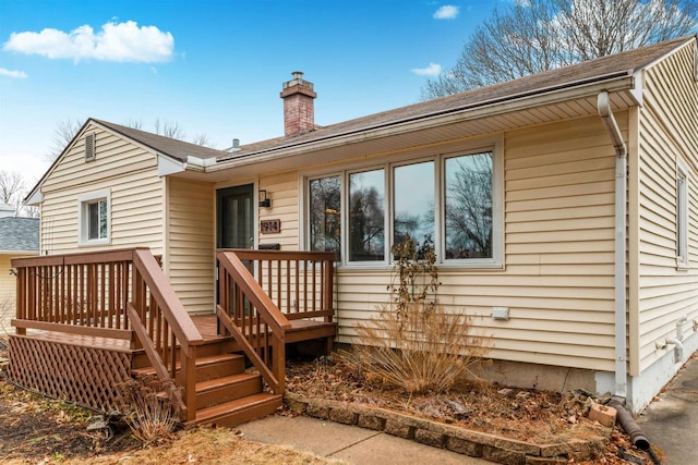 rear view of property with a wooden deck