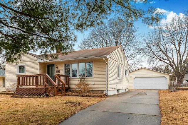 view of front of home featuring an outbuilding, a garage, and a front lawn