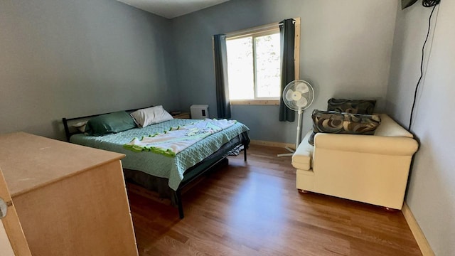 bedroom with wood-type flooring