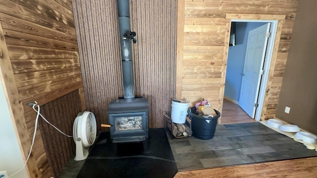 bathroom with hardwood / wood-style flooring, a wood stove, and wood walls