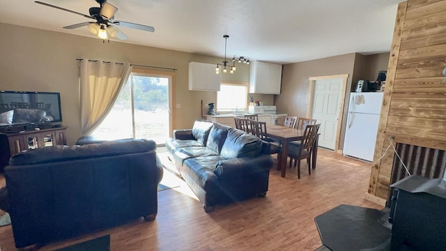 living room with ceiling fan and light wood-type flooring