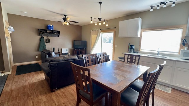 dining room featuring sink, light hardwood / wood-style floors, and ceiling fan