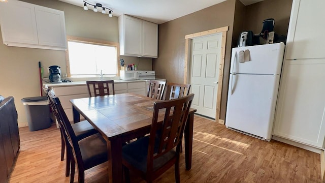 dining room with light wood-type flooring